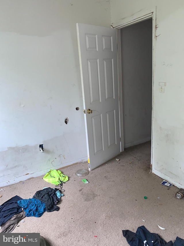 unfurnished room featuring light colored carpet