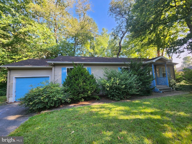 view of front of property featuring a garage and a front lawn