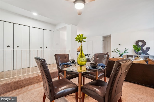 dining space with light carpet and ceiling fan