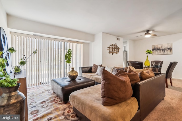 living room featuring carpet flooring and ceiling fan