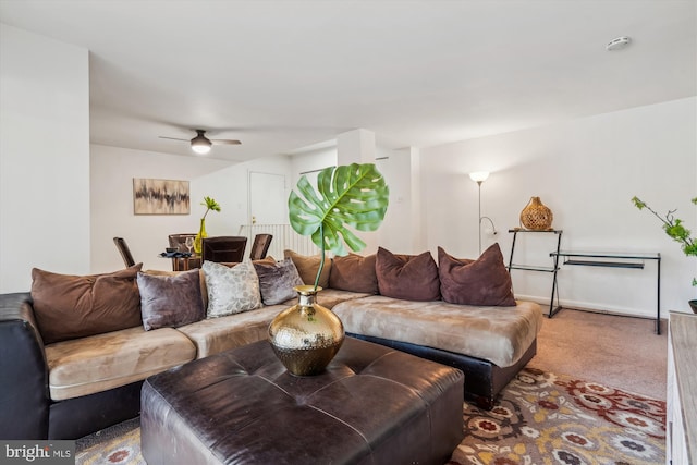 living room with ceiling fan and carpet