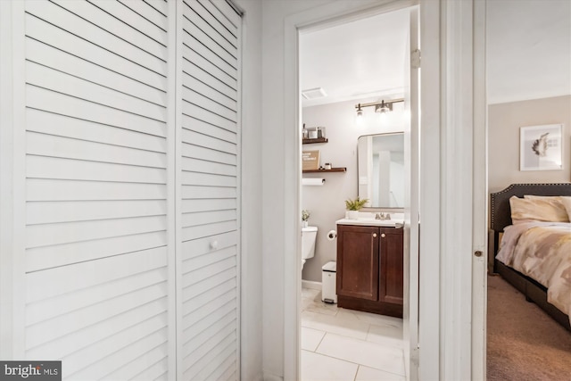 bathroom with vanity, toilet, and tile patterned floors