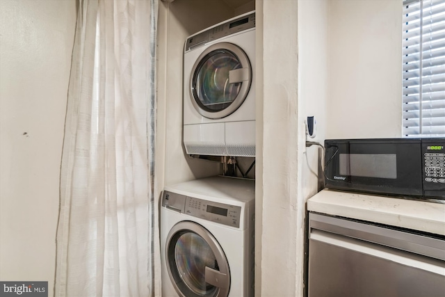 laundry room with stacked washer and dryer