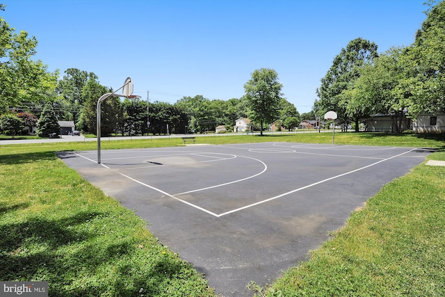 view of sport court with a lawn