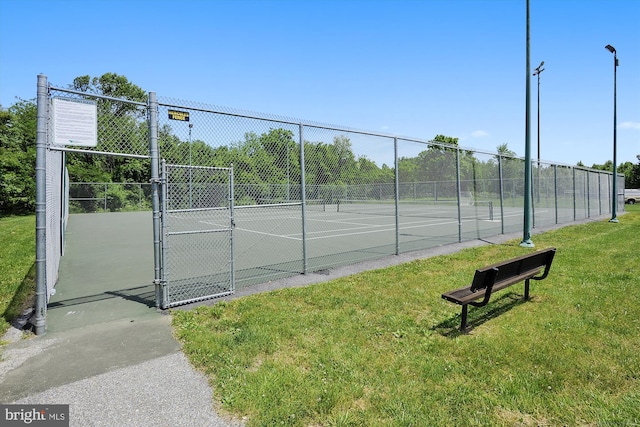 view of sport court featuring a yard