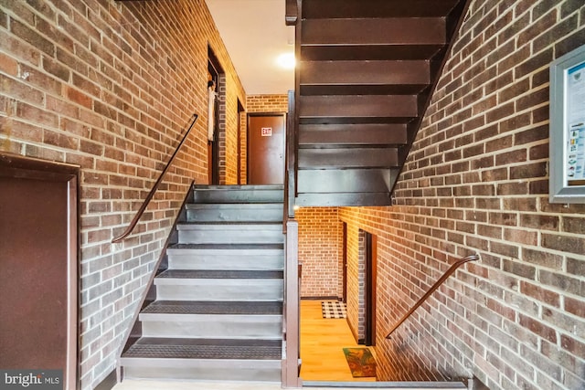 staircase with brick wall