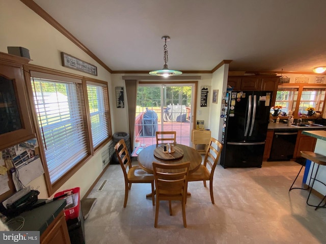 dining area featuring lofted ceiling and ornamental molding