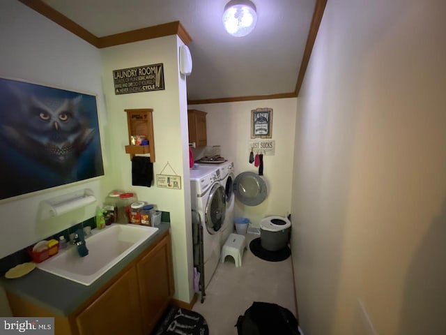 laundry area featuring cabinets, independent washer and dryer, ornamental molding, and sink