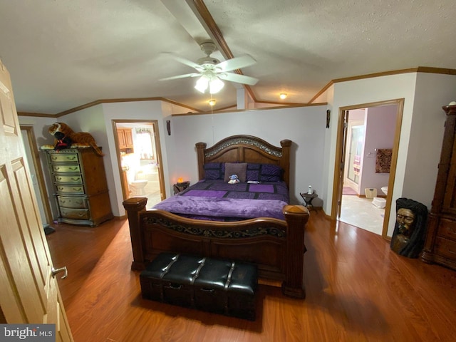 bedroom featuring wood-type flooring, ensuite bath, and ceiling fan