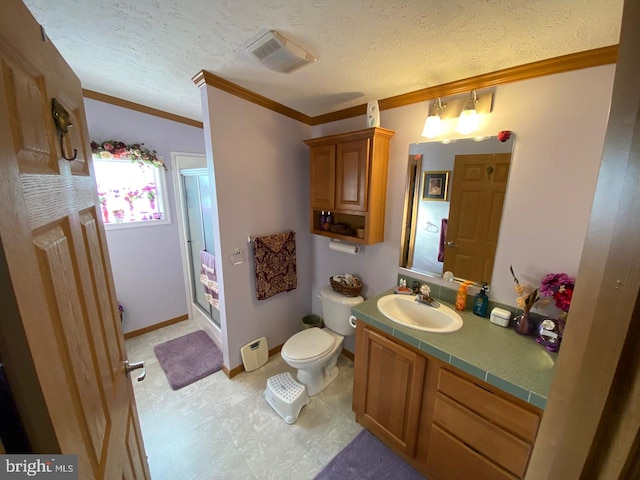 bathroom featuring ornamental molding, vanity, toilet, and a textured ceiling