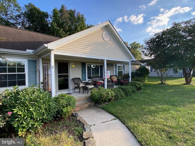 view of front facade with a front yard and covered porch