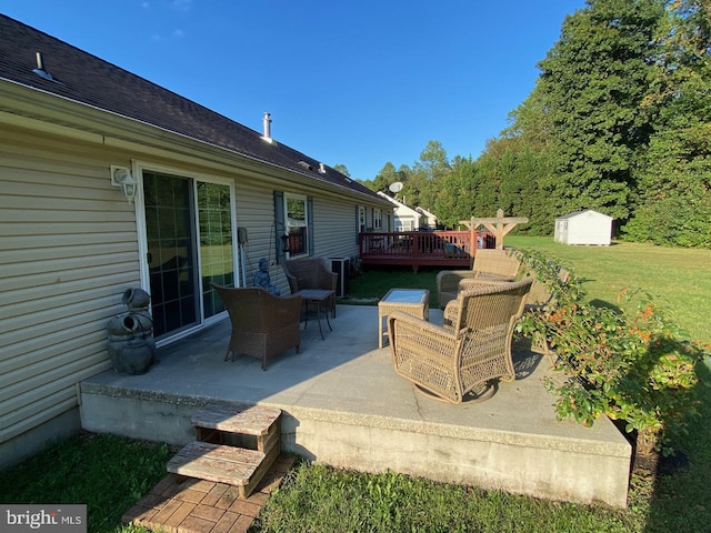 view of patio featuring a storage shed and a wooden deck