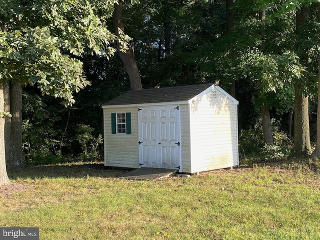 view of outdoor structure featuring a lawn