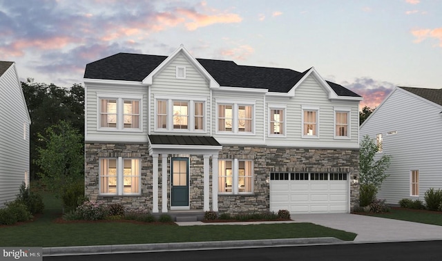 view of front of home with a yard and a garage