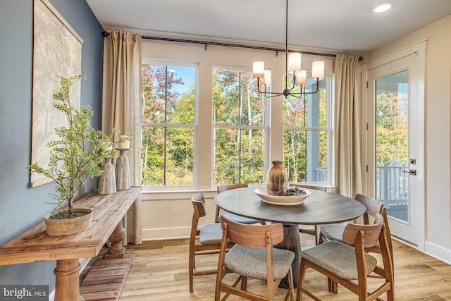 sunroom featuring a chandelier