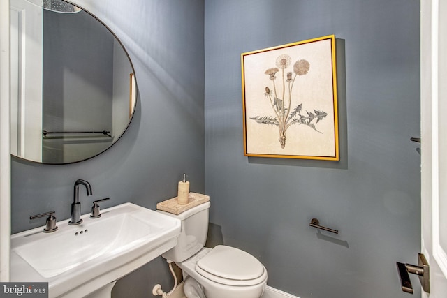 bathroom featuring toilet and sink