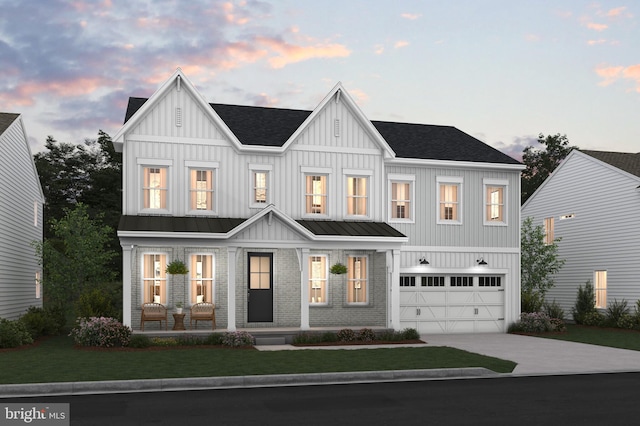 modern inspired farmhouse featuring a garage and a lawn