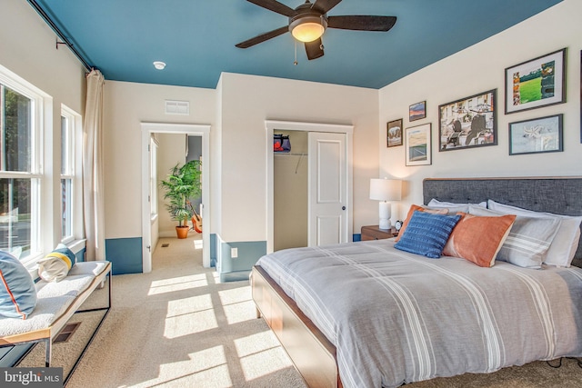 carpeted bedroom featuring a closet and ceiling fan