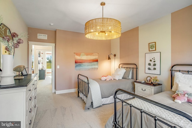 carpeted bedroom featuring a notable chandelier