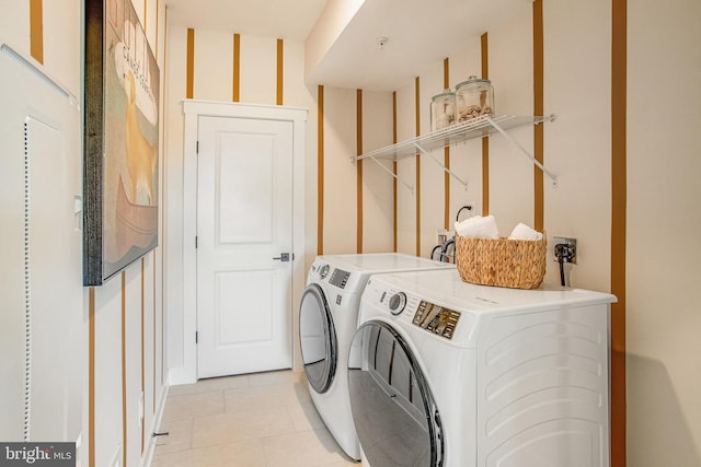 laundry room featuring separate washer and dryer and light tile patterned floors