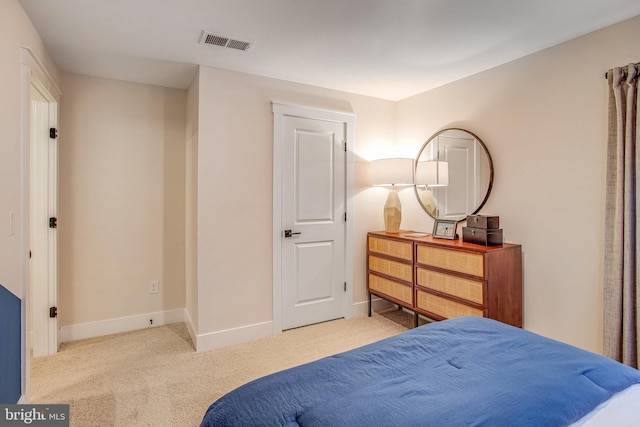 bedroom featuring light colored carpet