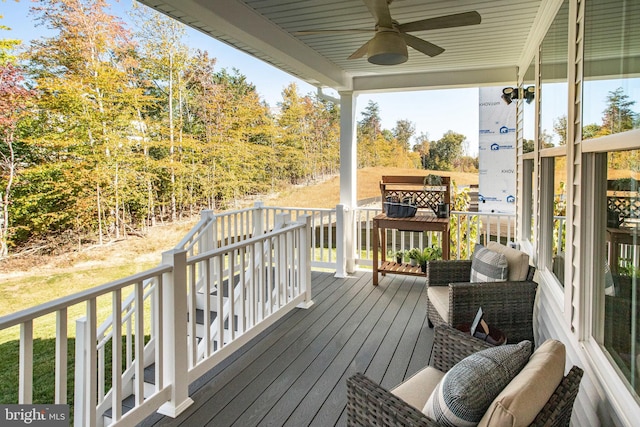 wooden deck featuring ceiling fan