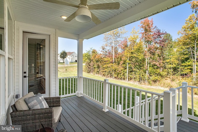 deck with a yard and ceiling fan