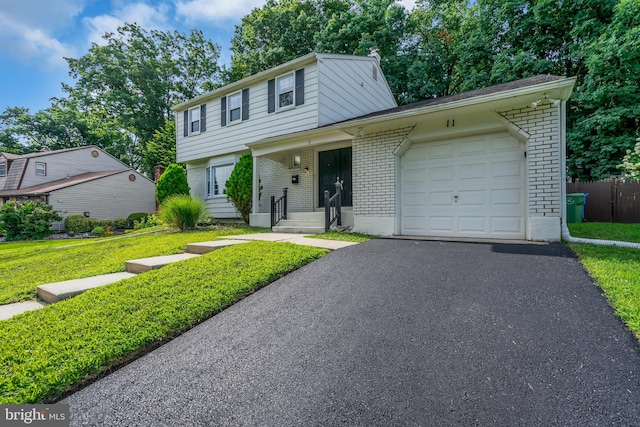 view of front of home featuring a garage, a porch, and a front lawn