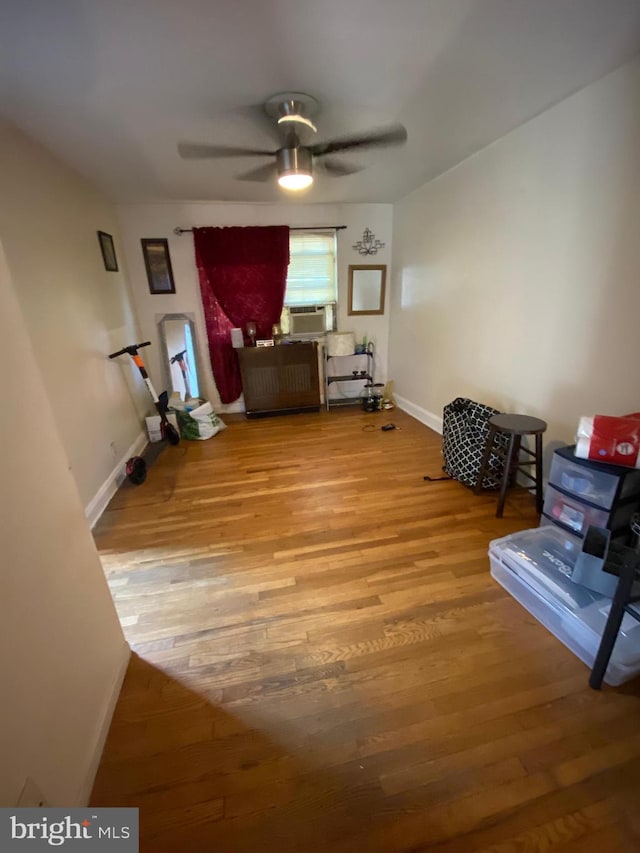 miscellaneous room featuring cooling unit, light hardwood / wood-style floors, and ceiling fan