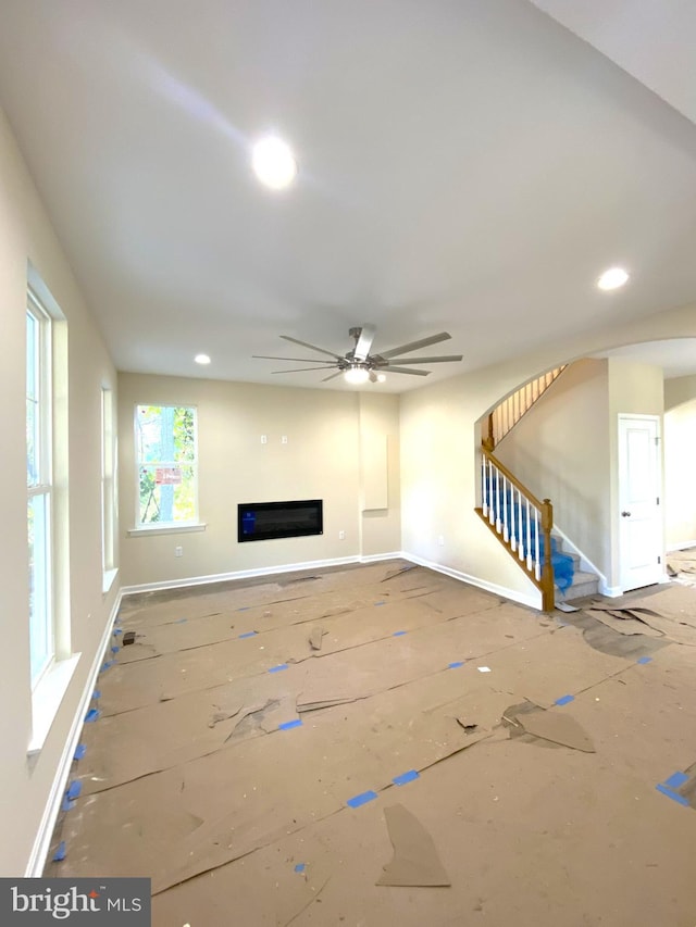 unfurnished living room with ceiling fan