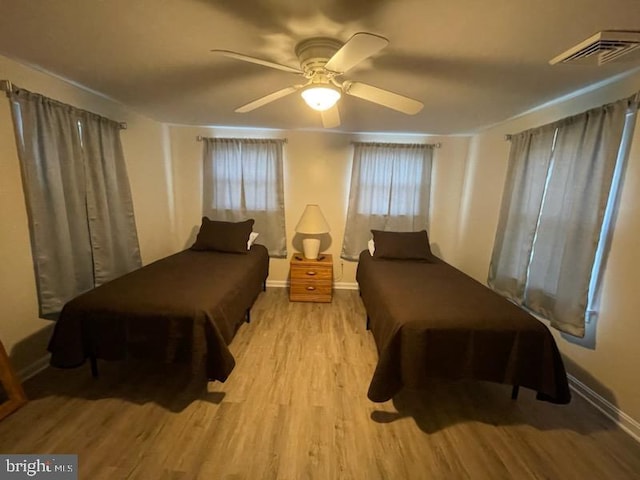 bedroom with light hardwood / wood-style flooring and ceiling fan