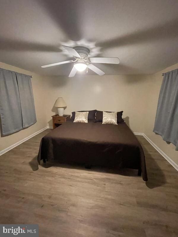 bedroom featuring hardwood / wood-style floors and ceiling fan