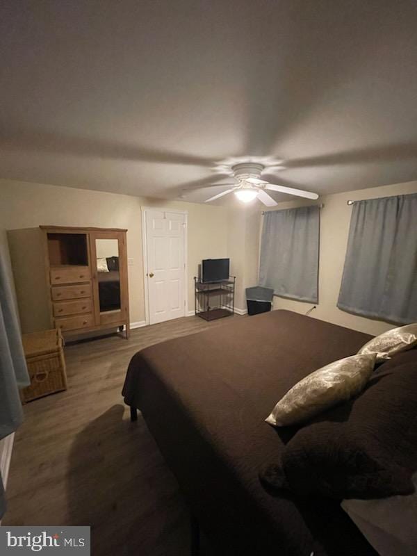 bedroom with hardwood / wood-style flooring and ceiling fan