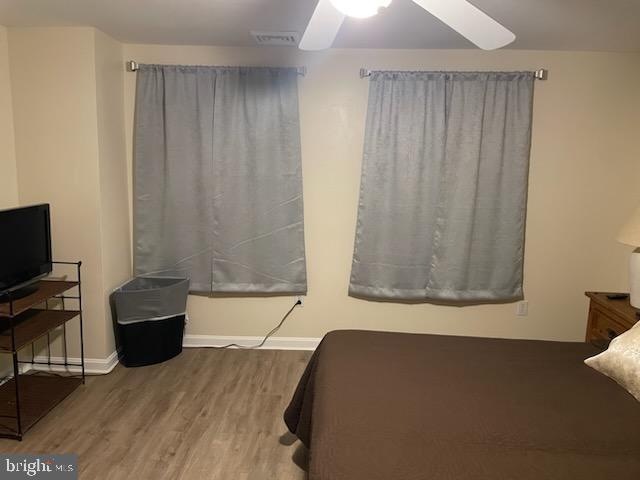 bedroom featuring hardwood / wood-style flooring and ceiling fan