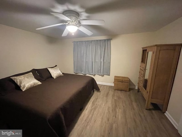 bedroom with light hardwood / wood-style flooring and ceiling fan