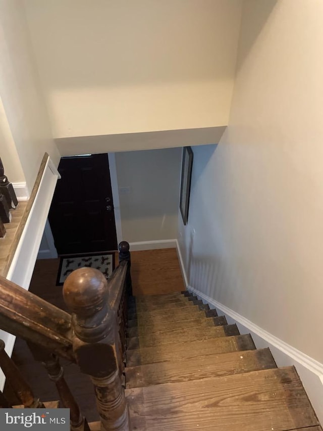 staircase with hardwood / wood-style floors