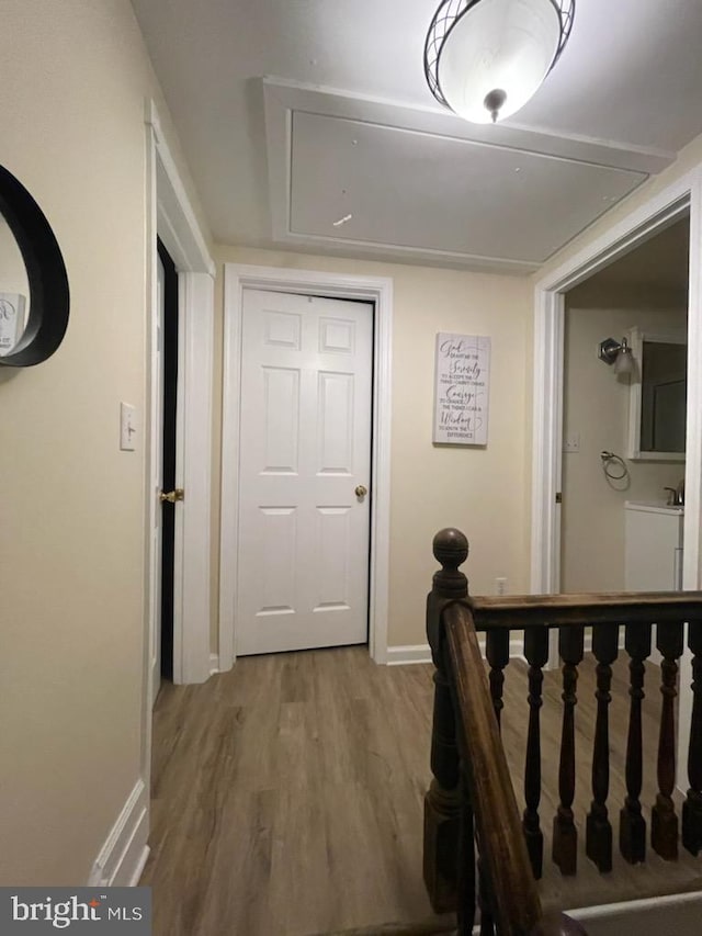 2826 Hoopers Island Rd, Church Creek, MD 21622 - corridor with attic access, wood finished floors, and baseboards