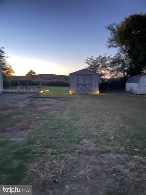 2826 Hoopers Island Rd, Church Creek, MD 21622 - yard at dusk with a shed and an outbuilding