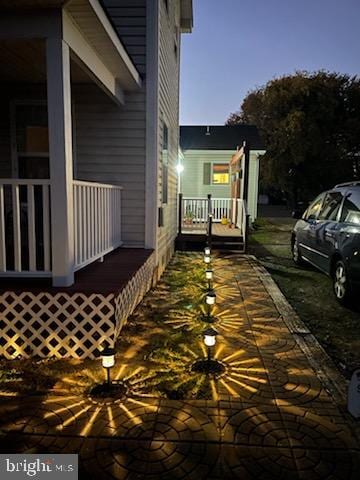 property exterior at dusk featuring a porch