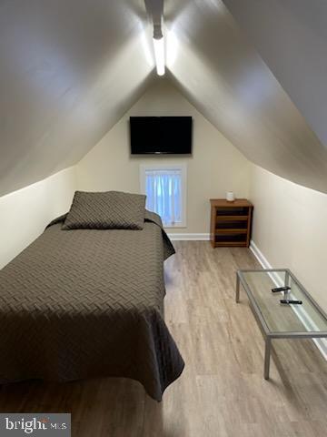 2826 Hoopers Island Rd, Church Creek, MD 21622 - bedroom featuring baseboards, wood finished floors, ceiling fan, and lofted ceiling