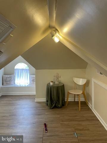 bonus room featuring lofted ceiling and dark wood-type flooring