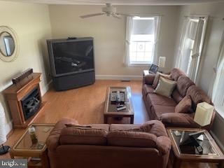 2826 Hoopers Island Rd, Church Creek, MD 21622 - living area with a ceiling fan, wood finished floors, and baseboards