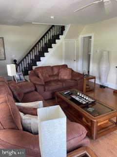 2826 Hoopers Island Rd, Church Creek, MD 21622 - living area featuring baseboards, stairway, and wood finished floors