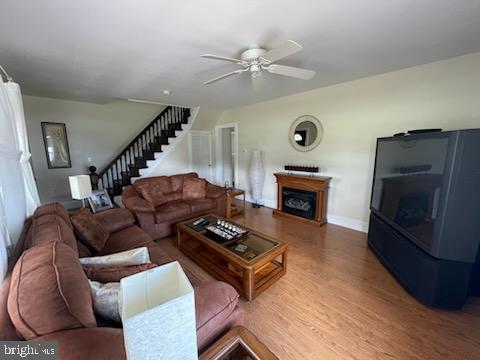 living room with hardwood / wood-style floors and ceiling fan