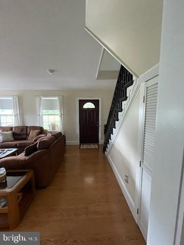2826 Hoopers Island Rd, Church Creek, MD 21622 - entryway with stairs, wood finished floors, and baseboards