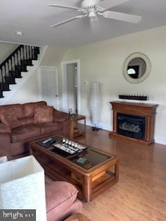 2826 Hoopers Island Rd, Church Creek, MD 21622 - living room with wood finished floors, a ceiling fan, stairs, and a fireplace