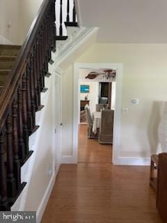 stairs featuring hardwood / wood-style flooring