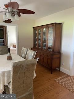 dining room with ceiling fan and dark hardwood / wood-style floors