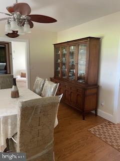 2826 Hoopers Island Rd, Church Creek, MD 21622 - dining space with baseboards, wood finished floors, and ceiling fan