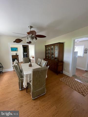 2826 Hoopers Island Rd, Church Creek, MD 21622 - dining space featuring a ceiling fan, wood finished floors, and baseboards